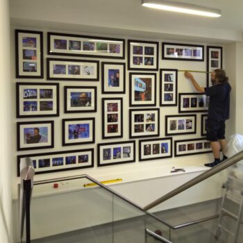 Hanging frames over a staircase